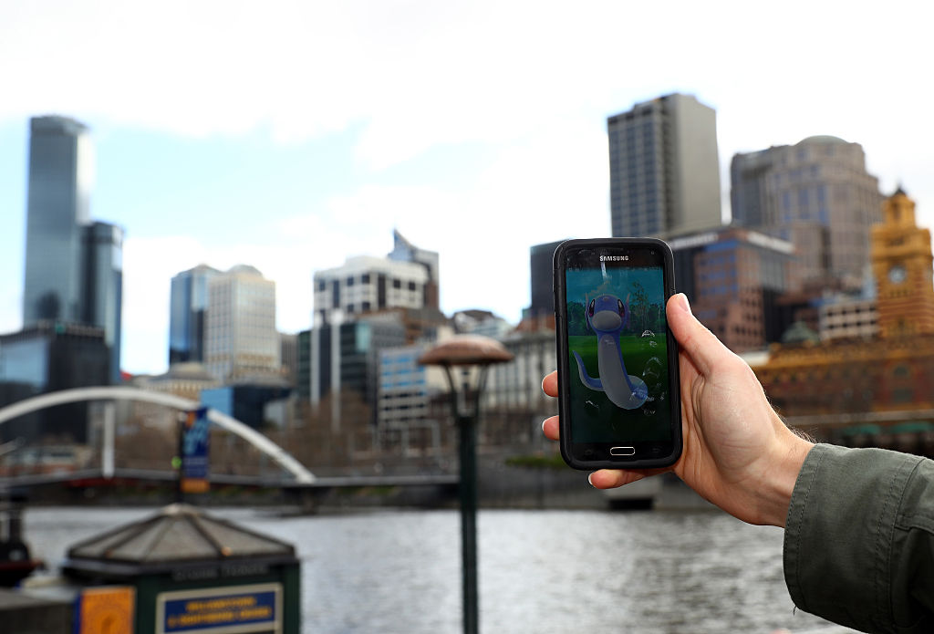 MELBOURNE, AUSTRALIA - JULY 13: A man holds up his phone as he plays the Pokemon Go game on July 13, 2016 in Melbourne, Australia. The augmented reality app requires players to look for Pokemon in their immediate surroundings with the use of GPS and internet services turning the whole world into a Pokemon region map. The hugely popular app has seen Nintendo shares soar following its limited release in the US, Australia and New Zealand on July 6. (Photo by Robert Cianflone/Getty Images)