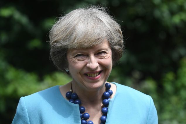 British Prime Minister Theresa May hosts a reception for the Police Bravery Award in the garden of 10 Downing Street in central London on July 14, 2016. Britain's new Prime Minister Theresa May showed several of her former cabinet colleagues the door Thursday, including top Brexit campaigner Michael Gove, while fellow "Leave" supporter Boris Johnson was crowned top diplomat. / AFP / POOL / Andrew Parsons