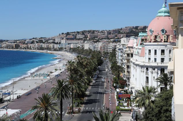 This picture taken on July 15, 2016, shows the site where a truck drove into a crowd watching a fireworks display on the Promenade des Anglais seafront near the Negresco Hotel in the French Riviera town of Nice on July 15, 2016. An attack in Nice where a man rammed a truck into a crowd of people left 84 dead and another 18 in a "critical condition", interior ministry spokesman Pierre-Henry Brandet said Friday. An unidentified gunman barrelled the truck two kilometres (1.3 miles) through a crowd that had been enjoying a fireworks display for France's national day before being shot dead by police. / AFP / Valery HACHE