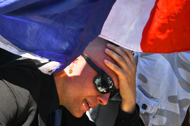 NICE, FRANCE - JULY 15: A man reacts as people visit the scene and lay tributes to the victims of a terror attack on the Promenade des Anglais on July 15, 2016 in Nice, France. A French-Tunisian attacker killed 84 people as he drove a lorry through crowds, gathered to watch a firework display during Bastille Day Celebrations. The attacker then opened fire on people in the crowd before being shot dead by police.