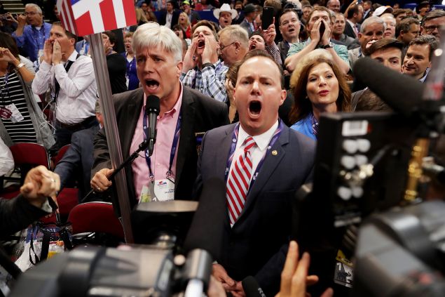 Sen. Mike Lee, center, and Phill Wright, Vice Chair of the Utah State Delegation shout 'no' to the adoption of rules without a roll call vote.