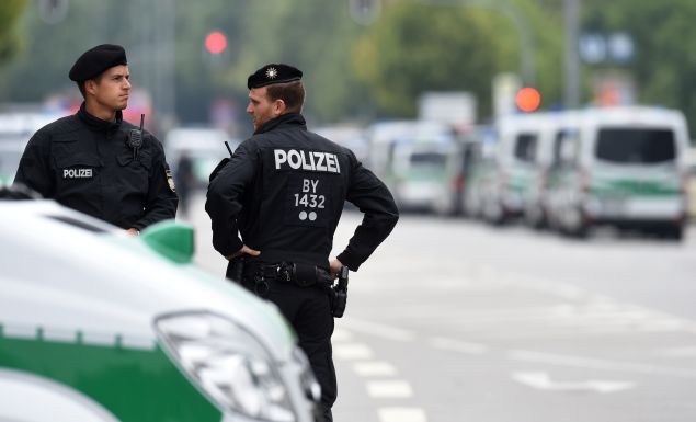 Police officers secure the area around the shopping mall Olympia Einkaufzentrum OEZ in Munich on July 23, 2016, a day after a gunman went on a shooting rampage, killing eight people in a suspected terror attack. The southern city was in lockdown after the shootings, which saw panicked shoppers fleeing the Olympia mall as armed anti-terror police roamed the streets in search of assailant. / AFP / Christof Stache
