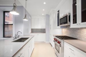 The kitchens feature Caesarstone countertops and shiny new appliances.