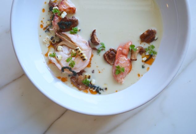Butter-poached lobster is served with a sweet corn veloute.