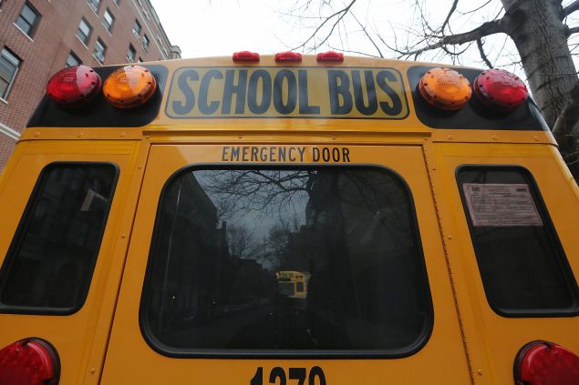 A school buses idles in front of a school in Manhattan's East Village on January 15, 2013 in New York City.  (Photo by Mario Tama/Getty Images)