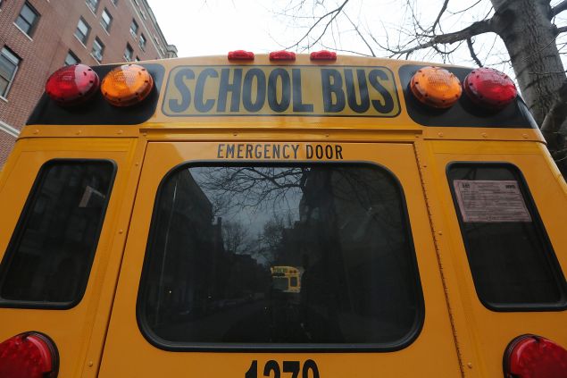 A school buses idles in front of a school in Manhattan's East Village on January 15, 2013 in New York City. (Photo by Mario Tama/Getty Images)