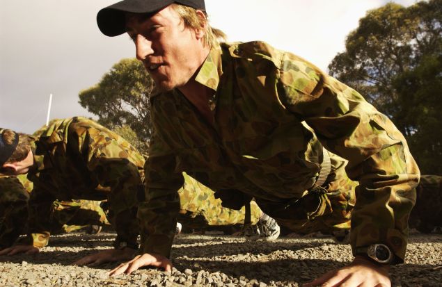 BALLARAT, AUSTRALIA - DECEMBER 4: Clint Bizell does push ups during a commando training session at the Melbourne Demons AFL Football Club pre season training camp at the Pax Scout Camp, Ballarat, Australia on December 4, 2002.