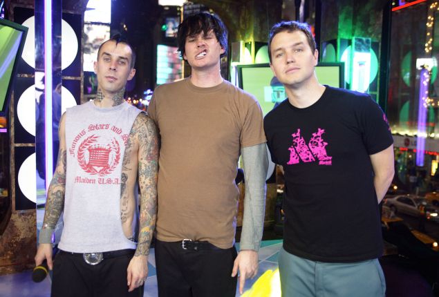 Blink 182 poses for a photo on stage during "Spankin' New Music Week" on MTV's Total Request Live at the MTV Times Square Studios November 11, 2003 in New York City.