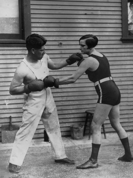 April 1926: American boxer Joe Rivers sparring with Louise Adler, the women's lightweight champion of the world, during a training session before she defends her title.