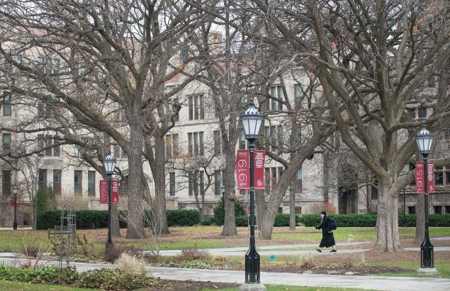 A Pedestrian walks through the Main Quadrangles (Quad) on the Hyde Park Campus of the University of Chicago on November 30, 2015 in Chicago, Illinois.