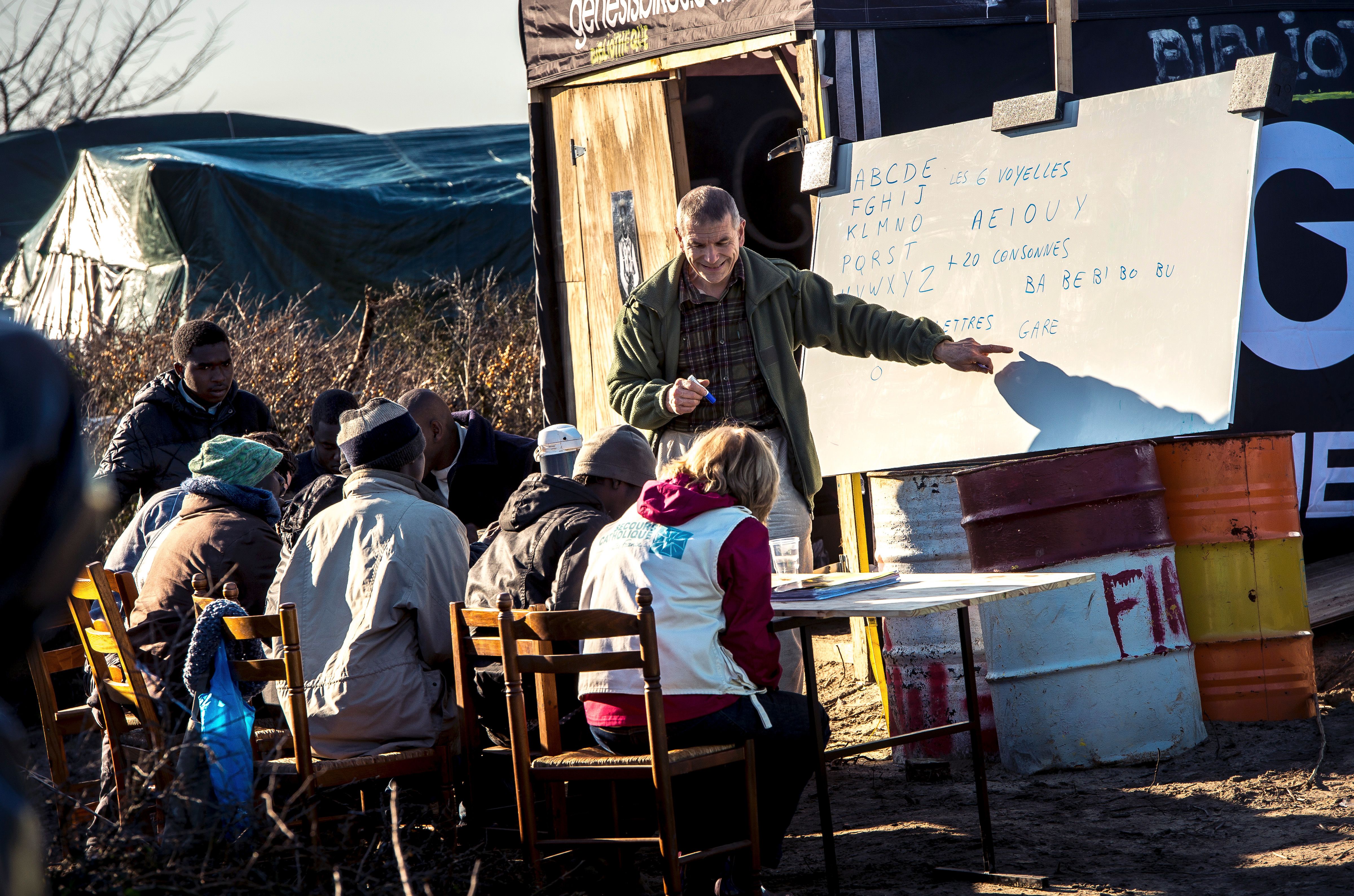 Migrant children are taught at a makeshift school in the "Jungle" camp in the port town of Calais, northern France in February 2016.
