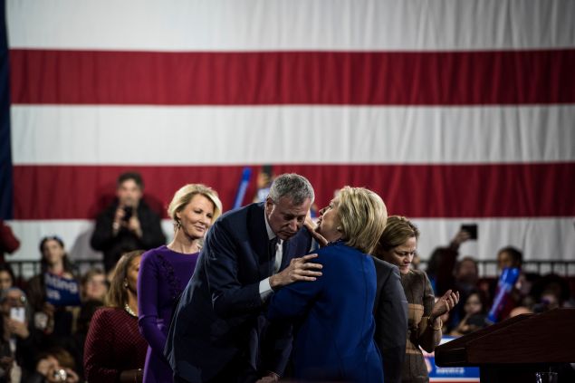 WITH ENDORSERS LIKE THESE... It was obvious all through 2015 that Mayor Bill de Blasio was desperate to make an impression on the presidential race. From his "Progressive Agenda" events at Gracie Mansion and outside the Capitol building in April and May 2015, to his scuttled plans to host both Democratic and GOP debates, the mayor seemed like an over-eager eight-year-old bouncing up and down to get the grown-ups' attention. Well, he finally got a little of that precious national notice he craved in April of this year—but it didn't come quite the way he wanted it. The mayor brought Hillary Clinton as his surprise guest to the April 9 Inner Circle show, an annual satire of NYC politics put on by reporters. De Blasio and Clinton did a little routine of their own onstage, where Clinton tweaked de Blasio over his belated decision to jump aboard her bandwagon with the rest of the political class. The mayor's excuse? "I was running on CP time," he said. That abbreviation usually stands for "colored people time," and hearkens to the stereotype that black people like to show up late. But here, Clinton helpfully explained, it meant "cautious politician time." Ba-dum tsh. The people in the room groaned and let it go. But a video of the skit escaped into the national news stream a couple days later, provoking some murmurings about sensitivity and the duo's horrible, horrible comic delivery. Clinton naturally blamed the bit of curdled comedy on the lesser Dem—and de Blasio got to be the laughingstock of the whole country and not just New York for a change. Would people have gotten so upset if it hadn't been such a godawful creaking awkward joke? The world may never know.