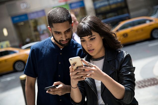 NEW YORK, NY - JULY 11: (L to R) Sameer Uddin and Michelle Macias play Pokemon Go on their smartphones outside of Nintendo's flagship store, July 11, 2016 in New York City. The success of Nintendo's new smartphone game, Pokemon Go, has sent shares of Nintendo soaring. (Photo by Drew Angerer/Getty Images)
