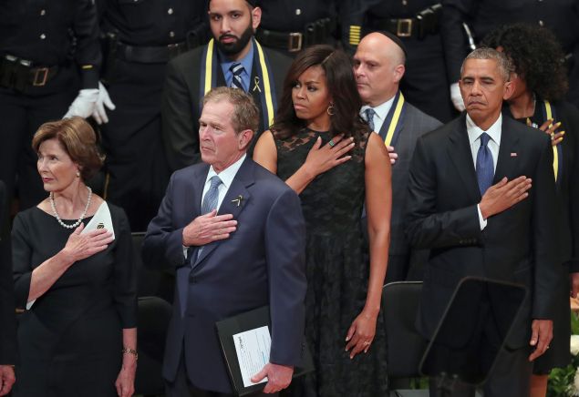 Former first lady Laura Bush, former U.S. President George W. Bush, first lady Michelle Obama and U.S. President Barack Obama join in singing the 'Star-Spangled Banner' during an interfaith memorial service, honoring five slain police officers, at the Morton H. Meyerson Symphony Center on July 12, 2016 in Dallas, Texas.