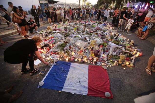 People gather and lay tributes on the Promenade des Anglais on July 17, 2016 in Nice, France.A French-Tunisian attacker killed 84 people as he drove a lorry through crowds, gathered to watch a firework display during Bastille Day Celebrations. The attacker then opened fire on people in the crowd before being shot dead by police.