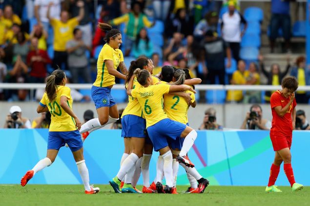 Brazil players celebrate as Monica scores their first goal during the Women's Group E first round match between Brazil and China PR during the Rio 2016 Olympic Games at the Olympic Stadium on August 3, 2016.