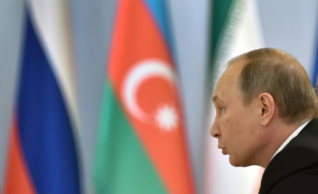 Russian President Vladimir Putin makes a speech during a meeting with his Azerbaijani counterpart Ilham Aliyev and Iranian leader Hassan Rouhani in Baku on August 8, 2016. The talks between Russian President Vladimir Putin, his Azerbaijani counterpart Ilham Aliyev and Iranian leader Hassan Rouhani are focused on the North-South Transport Corridor -- the ship, rail, and road route for freight between India, Russia, Iran, Europe and Central Asia -- and more generally on economy and trade as well as anti-terrorism cooperation.