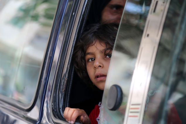 A Syrian child in a vehicle looks on in the northern Syrian town of Manbij as civilians go back to their homes on August 14, 2016 more than a week after the Arab-Kurdish alliance, known as the Syrian Democratic Forces (SDF), pushed the Islamic State (IS) group out of the city. The last remaining IS fighters abandoned the city of Manbij near the Turkish border on August 12, 2016 after a rout the Pentagon said showed the extremists were "on the ropes". The retreat from the city which IS captured in 2014 was the jihadists' worst defeat yet at the hands of the SDF backed by US air power.