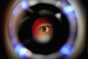 LONDON - OCTOBER 14: A man uses an iris recognition scanner during the Biometrics 2004 exhibition and conference October 14, 2004 in London. The conference will examine the role of new technology such as facial recognition and retinal scans to determine identity to improve security.