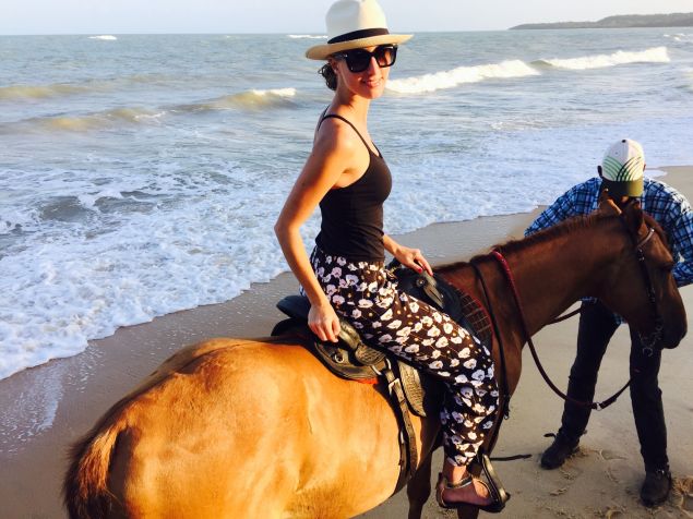 Riding horses by the sea