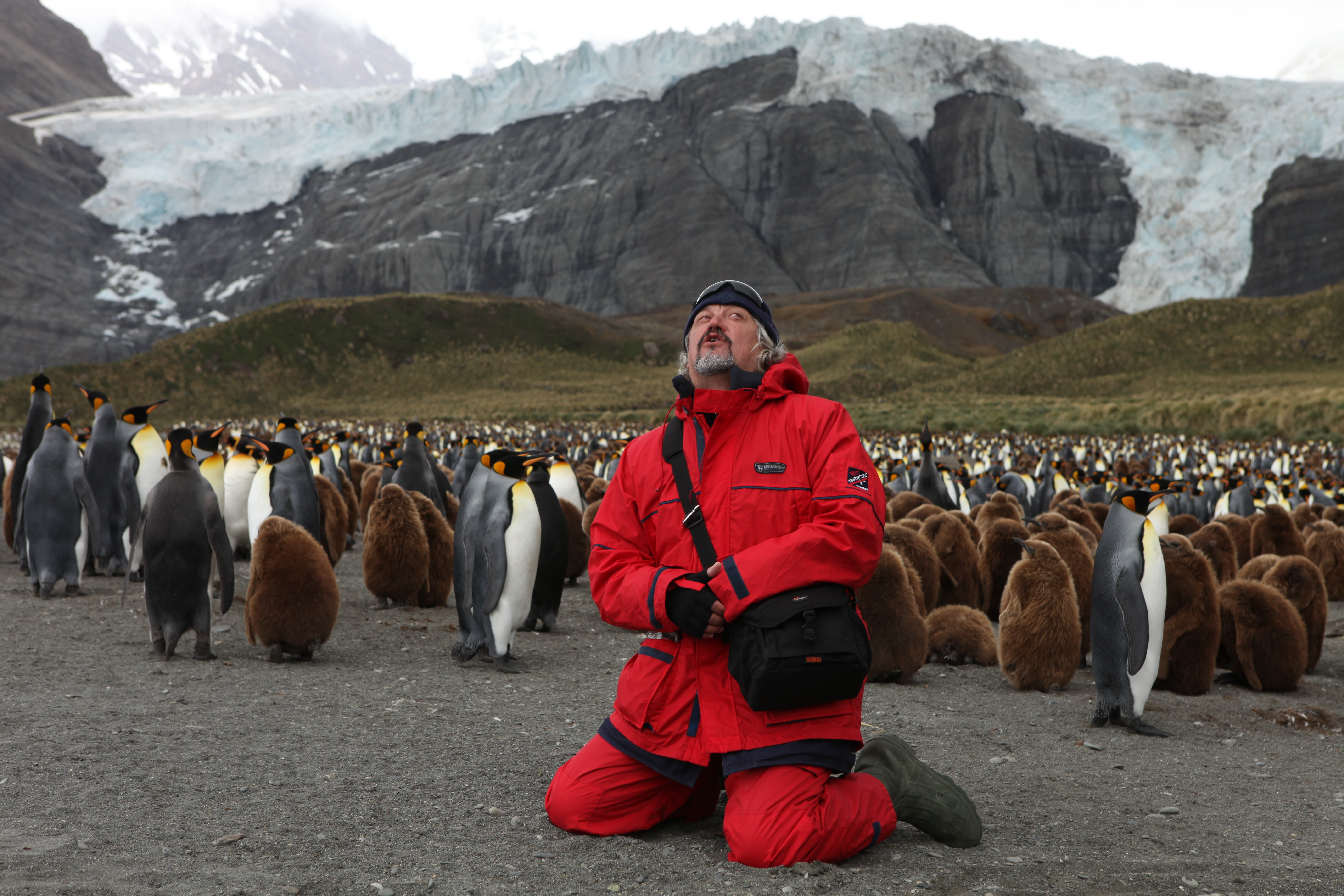 Ponomarev with penguins in Antarctica.