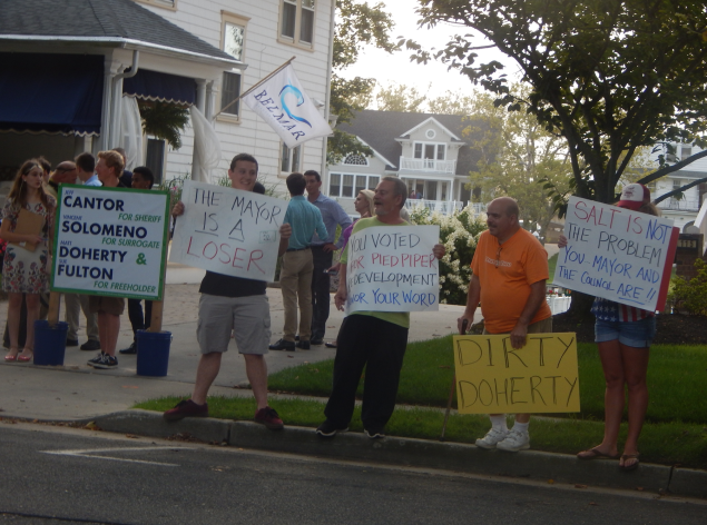 Protestors bearing pro-Trump signs gathered outside a fundraiser hosted at the mayor of Belmar's home last week. Democrats claim they were paid to do it.