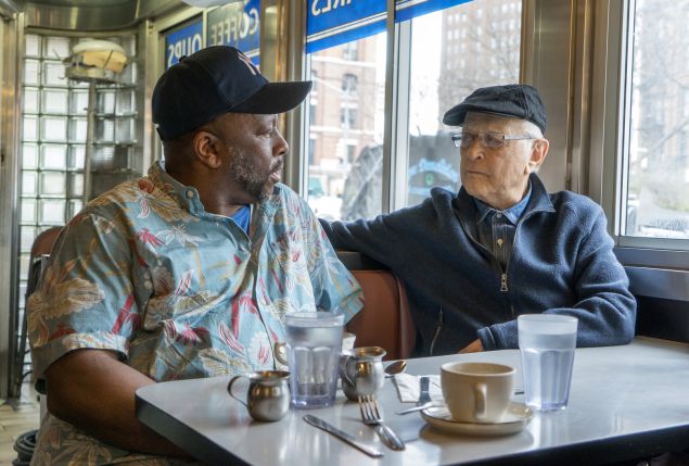Rob Robinson, left, with producer Norman Lear in a scene from the documentary, “America Divided.”