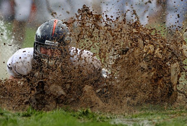 NFL Players in mud