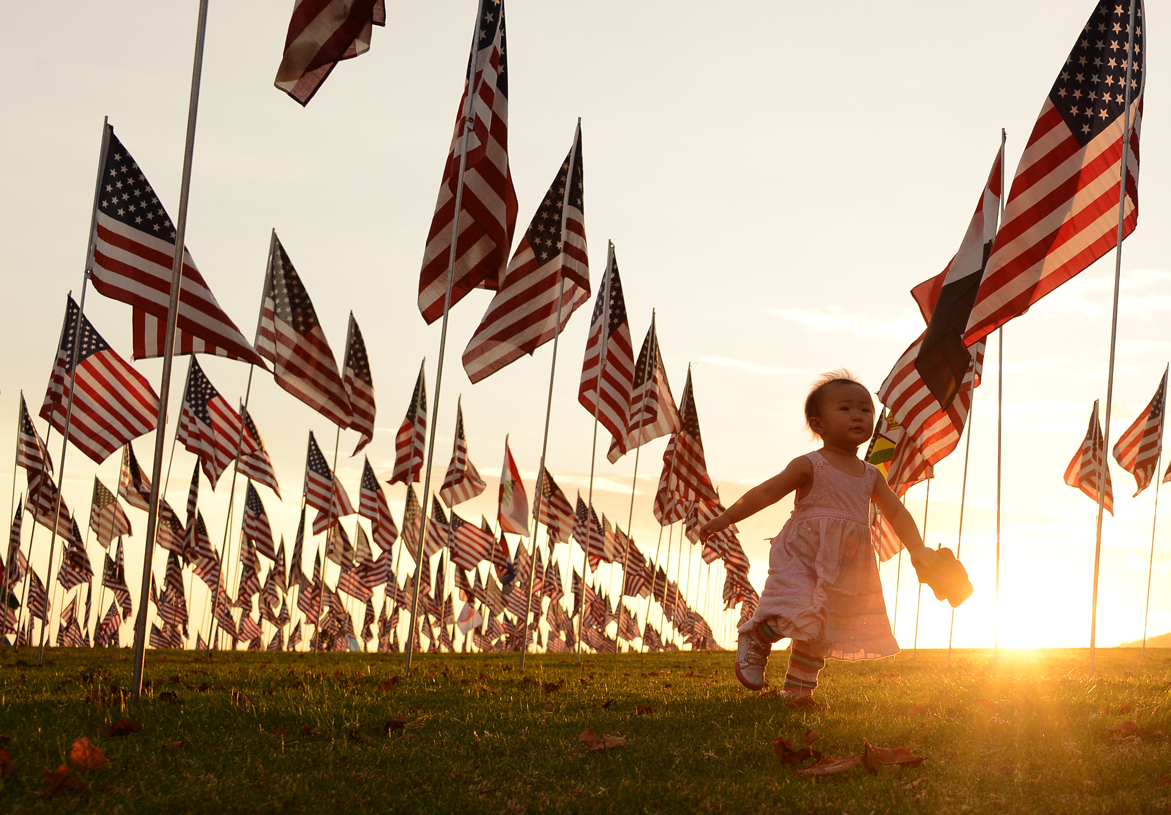 Collective trauma: A child walks amongst US national flags erected to honor victims of the 9/11 attacks.