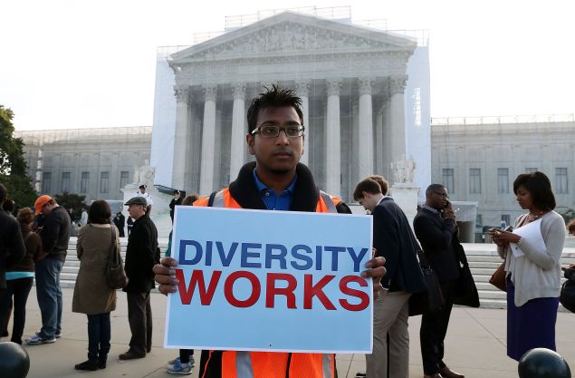 Travis Ballie holds a sign that reads (Diversity Works) in front of the U.S. Supreme Court on October 10, 2012 in Washington, DC.