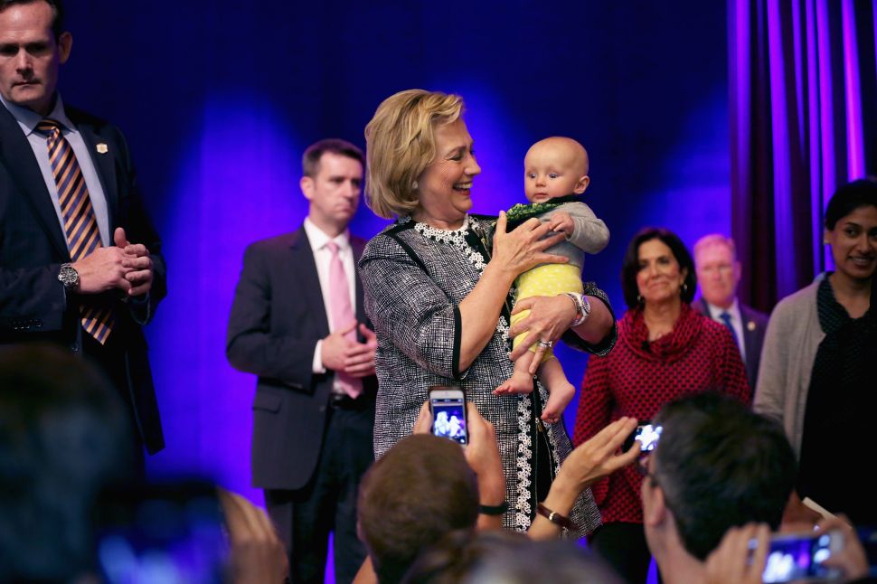 Former Secretary of State Hillary Clinton holds an audience member's baby after discussing her new book, 'Hard Choices: A Memoir,' at the Lisner Auditorium on the campus of George Washington University June 13, 2014 
