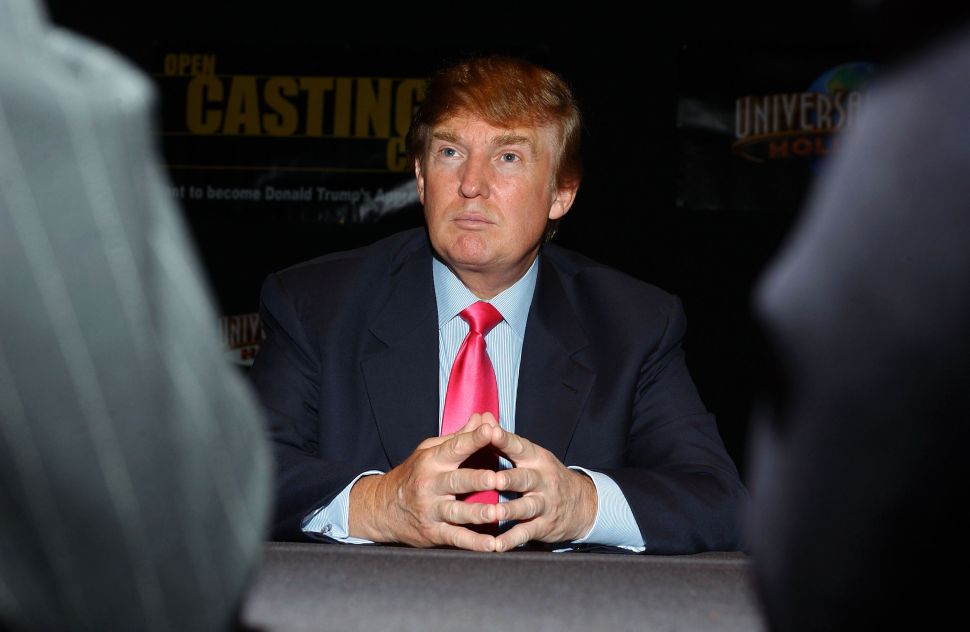  Businessman Donald Trump listens as potential contestants discuss their opinions on the first stop of the 16 city 'The Apprentice' Recruiting Tour on July 9, 2004 at Universal Studios Hollywood in Universal City, California. 