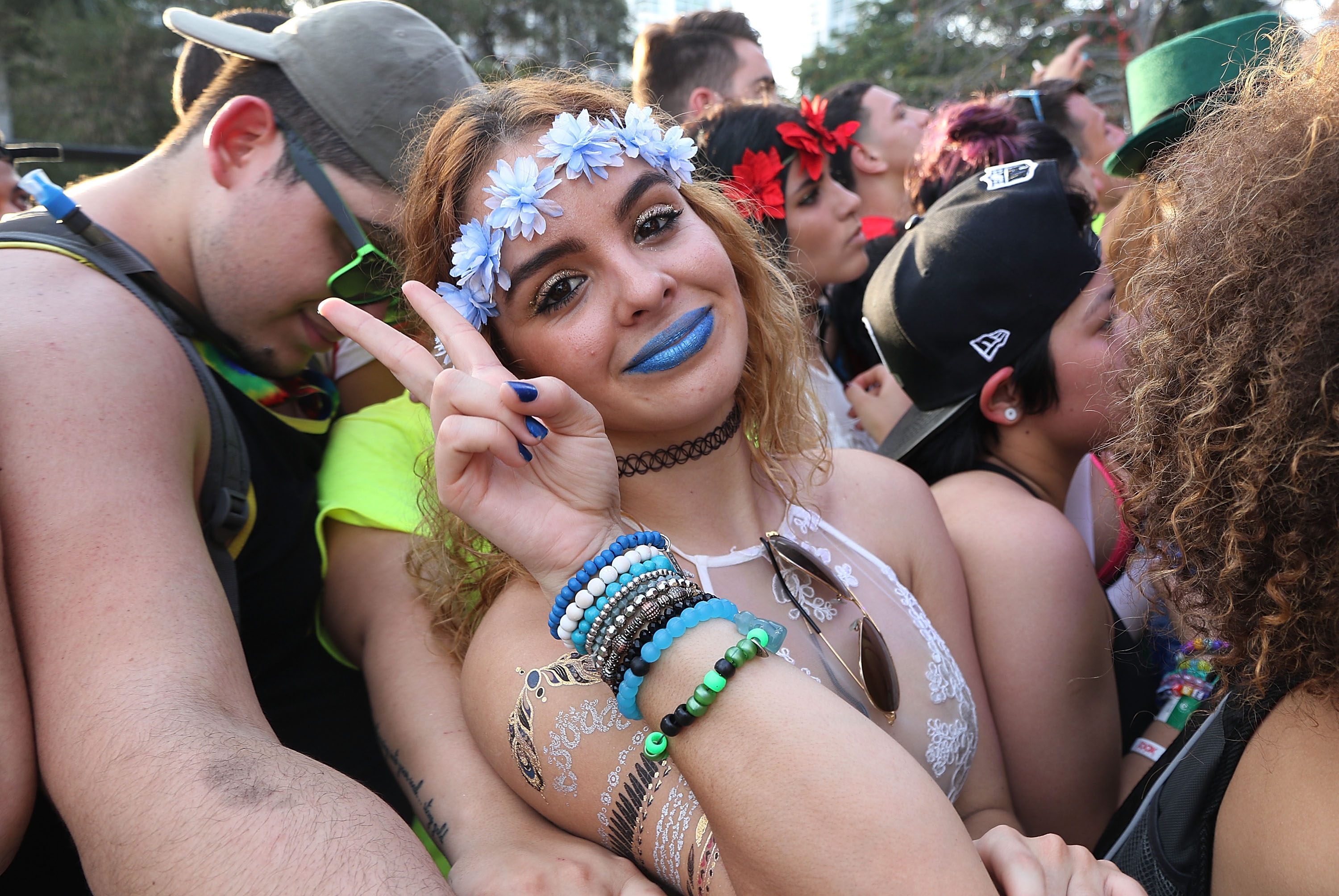 Through this young woman's flower crown and peace sign, the chemically-induced decadence of the '60s survives, but the culture of art and the youth in revolt does not. The new 'love crowd' are simply consumers.
