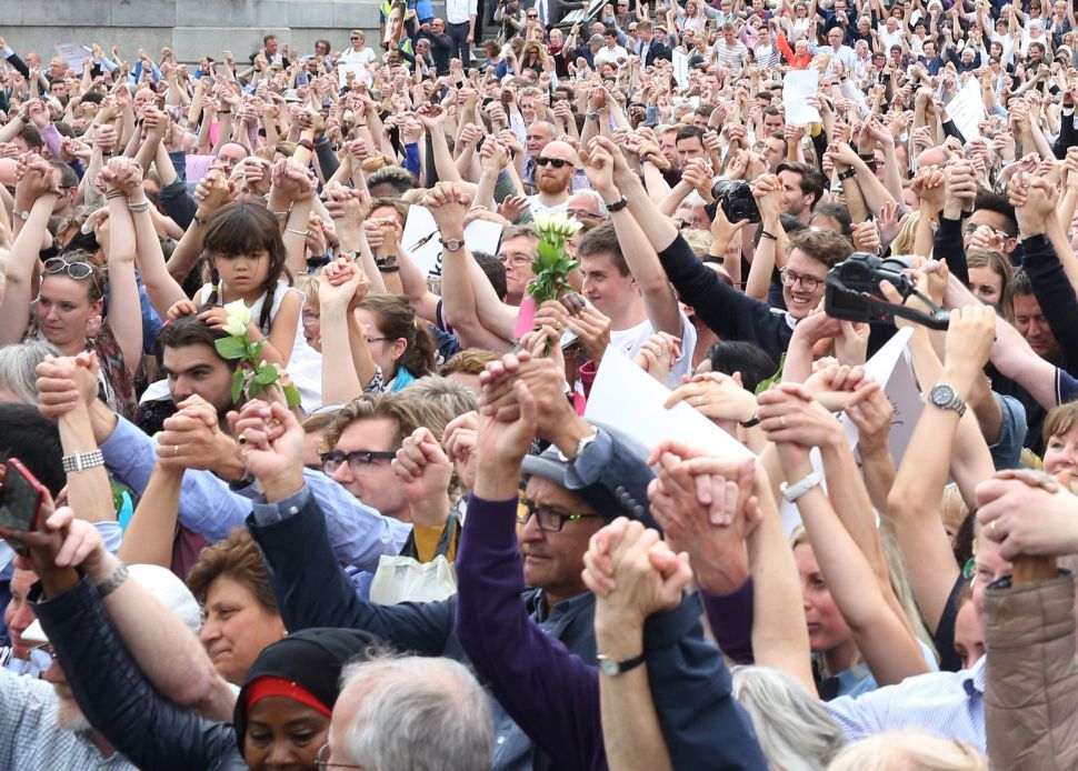 Members of the crowd attending a commemorative event to celebrate the life of murdered Labour MP Jo Cox link hands as a show of unity in Trafalgar Square, central London, on June 22, 2016, on what would have been Jo's 42nd birthday. Murdered British MP Jo Cox's family marked what would have been her 42nd birthday on June 22 with a river tribute and a rally in London on the eve of Britain's European Union referendum. The commemoration in the city's central Trafalgar Square was set to be matched with similar events taking place in cities around the world, among them Beirut, Nairobi, New York and Paris.