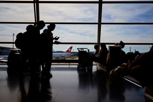 Passengers wait on July 6, 2016 at the Zurich Airport in Zurich.