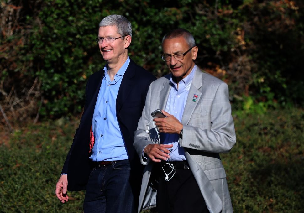 Apple CEO Tim Cook (L) and Hillary Clinton campaign chairman John Podesta leave a fundraiser for Hillary Clinton on August 24, 2016 in Los Altos Hills, California.