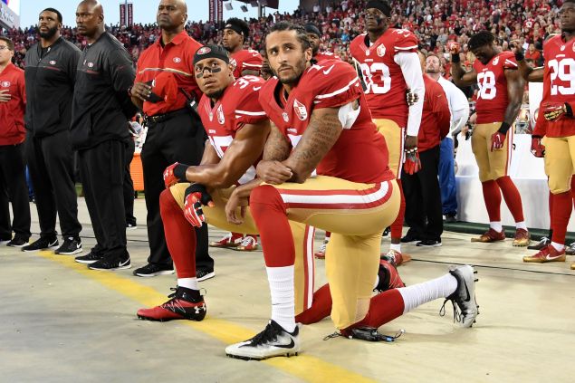 Colin Kaepernick #7 and Eric Reid #35 of the San Francisco 49ers kneel in protest during the national anthem prior to playing the Los Angeles Rams in their NFL game at Levi's Stadium on September 12, 2016 in Santa Clara, California. 