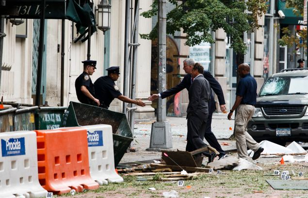 NEW YORK, NY - SEPTEMBER 18: New York Mayor Bill de Blasio (rear) and New York Governor Andrew Cuomo (2-R) tour the site of an explosion that occurred on September 18, 2016 in Chelsea. 