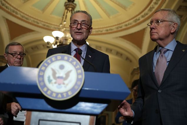 U.S. Sen. Charles Schumer (D-NY) (C) speaks as Senate Minority Whip Sen. Richard Durbin (D-IL) (L) and Senate Minority Leader Sen. Harry Reid (D-NV) (R) listen during a news briefing after a weekly policy luncheon at the Capitol September 20, 2016 