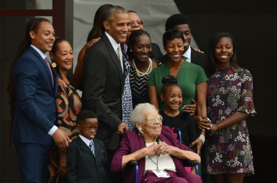 President Barack Obama and four generations of the Bonner family, who are descendants of slaves, stand together to have their picture taken after ringing the First Baptist Church Bell to officially open the Smithsonian's National Museum of African American History and Culture in Washington, DC, September 24, 2016.