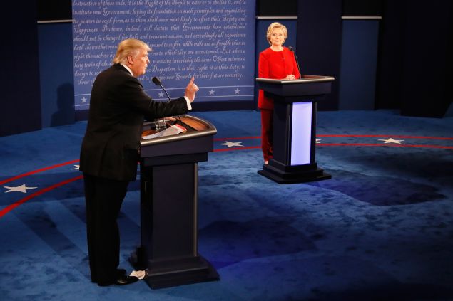 Republican presidential nominee Donald Trump (L) speaks as Democratic presidential nominee Hillary Clinton (R) listens during the Presidential Debate at Hofstra University on September 26, 2016 in Hempstead, New York