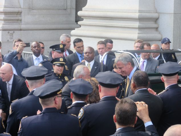 Outgoing Police Commissioner Bratton and Mayor de Blasio after sharing a hug on his last day.