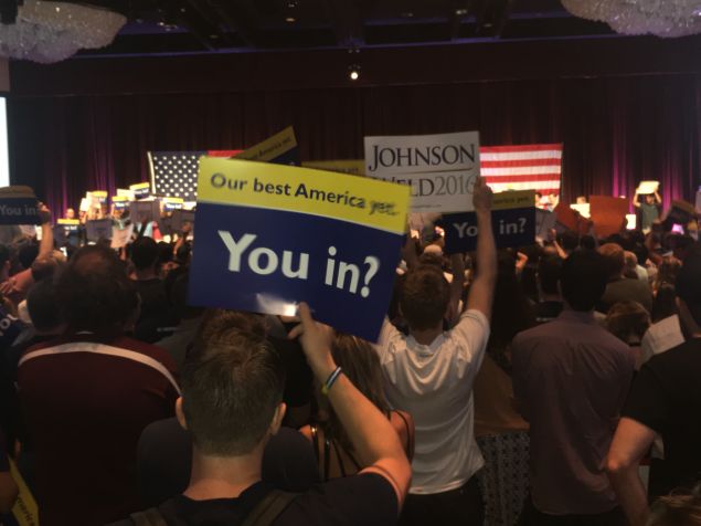 The crowd raises campaign signs before Gov. Gary Johnson steps onstage.