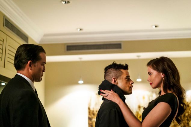 (l-r) Jeremy Holm as Mr. Sutherland, Rami Malek as Elliot Alderson and Stephanie Corneliussen as Joanna Wellick.