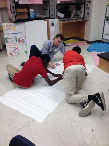 A Sci-Inspire volunteer helps a Washington, D.C. high school student with a science project.