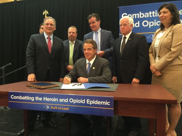 Nassau County Executive Edward Mangano, left, stands beside Gov. Andrew Cuomo and a host of Long Island officials.