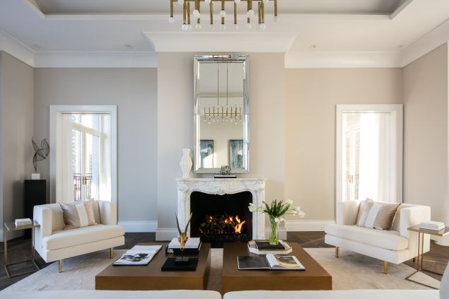 A fireplace with a marble mantle and a neutral color palette in one of Cheryl Eisen's Park Avenue projects.