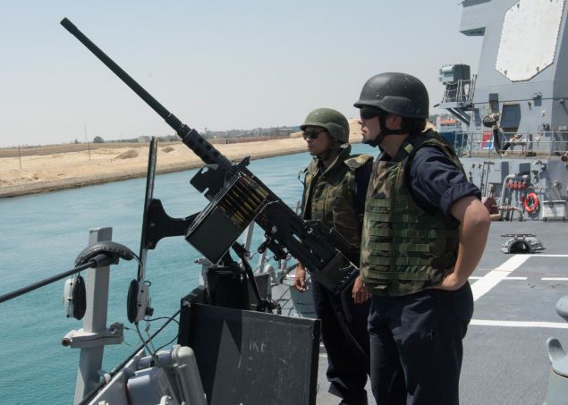 Fire Controlman 2nd Class Ariana Friedrichs, right, and Information Systems Technician 3rd Class Phillip Aradanas man a .50-caliber machine gun while transiting the Suez Canal aboard the guided-missile destroyer USS Mason (DDG 87) in the Suez Canal.