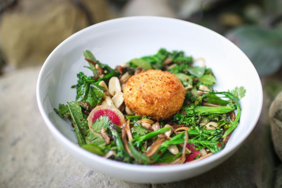 Miles Thompson serves blistered baby broccoli with pig ears and an egg on top at Michael's Santa Monica.