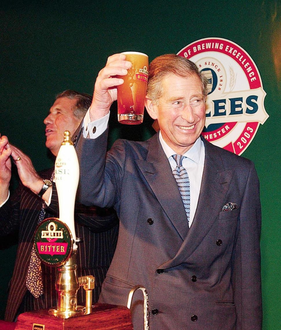 The Prince of Wales toasts guests with a pint of beer he pulled from the pump himself during a visit to the JW Lees Brewery at Middleton near Manchester, 17 November 2003. 